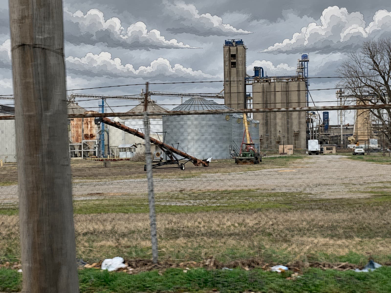 Grain elevator yard under an overcast sky